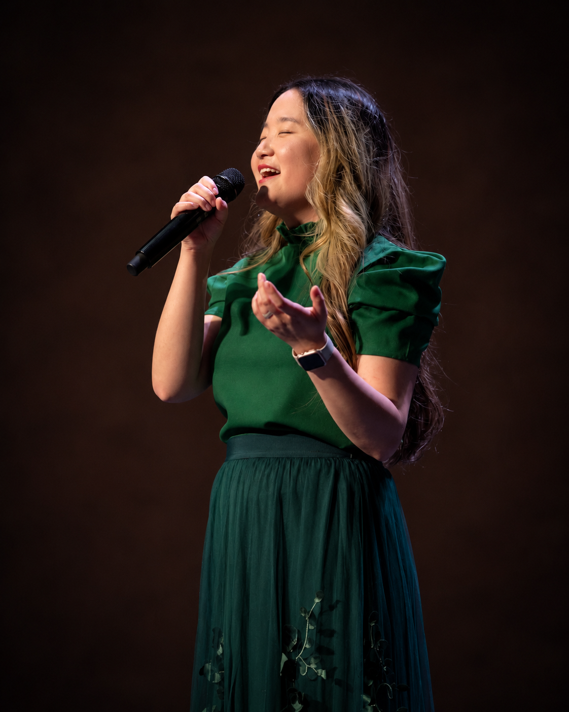 Chloe Cox performing in green dress