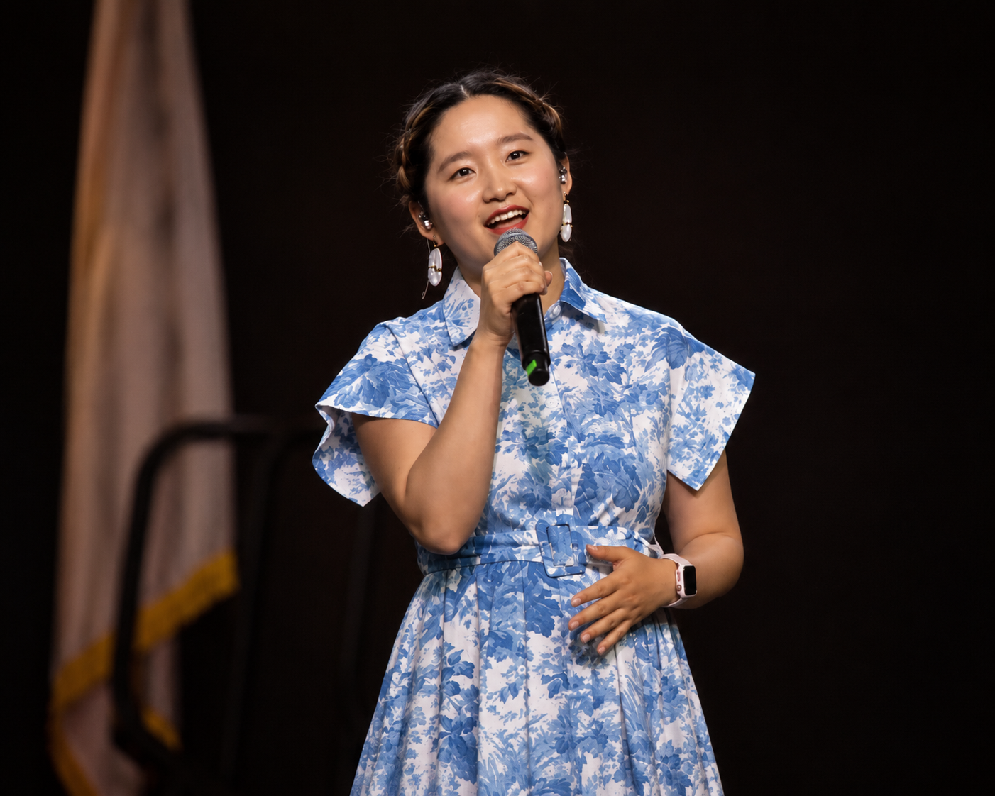 Chloe Cox performing in blue floral dress